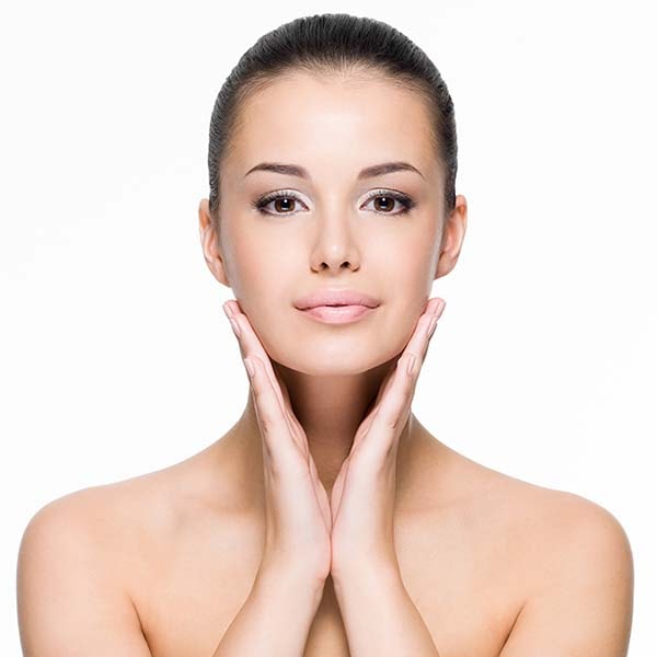 Woman with hands on jawline with perfect skin